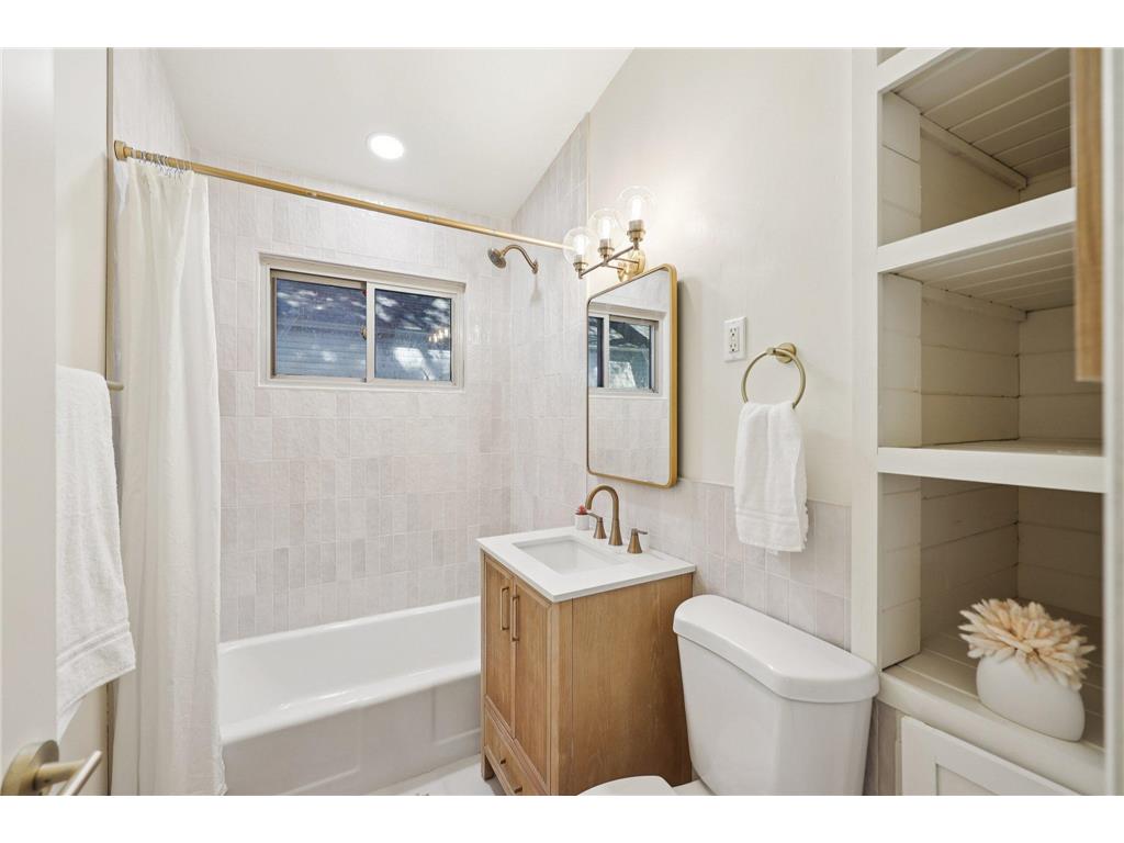 Renovated bathroom with brass fixtures